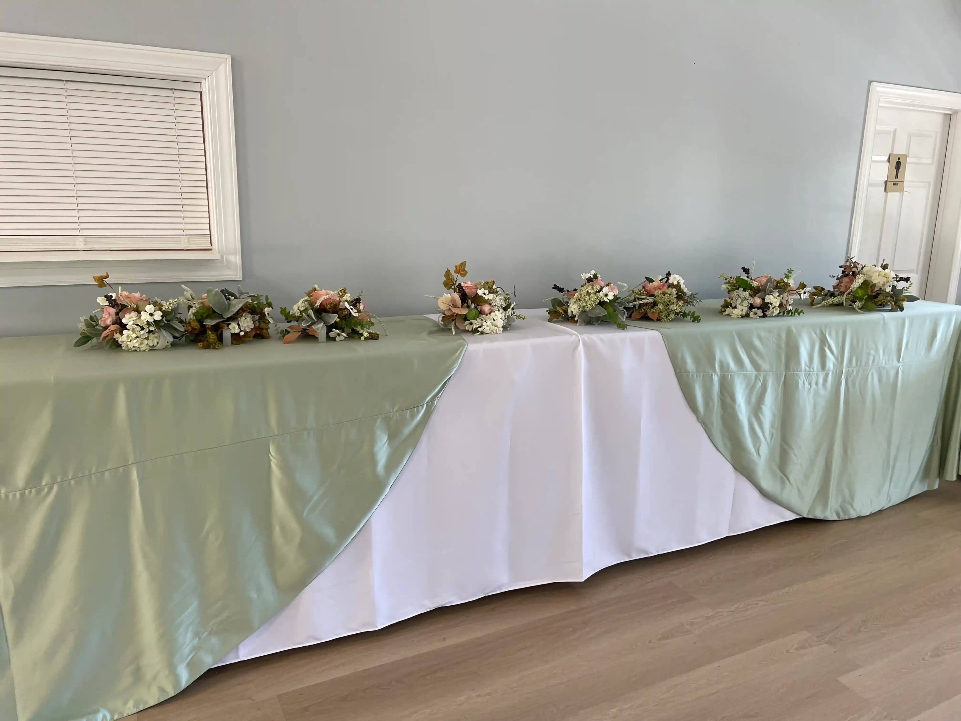 Sage and white wedding decor with elegant floral arrangements