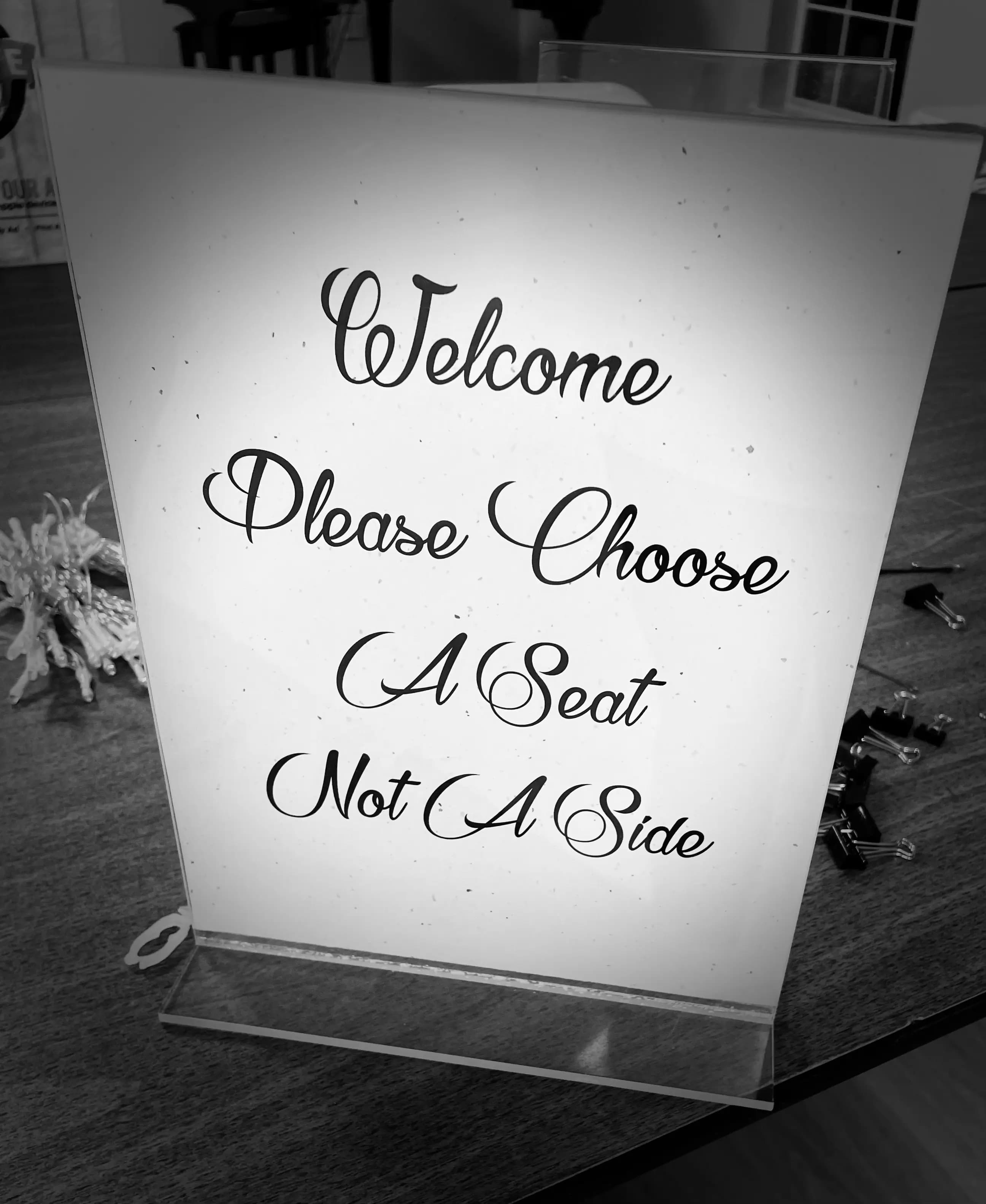Welcome take a seat sign